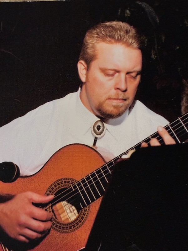 James C. Robbins performing live at a bar
